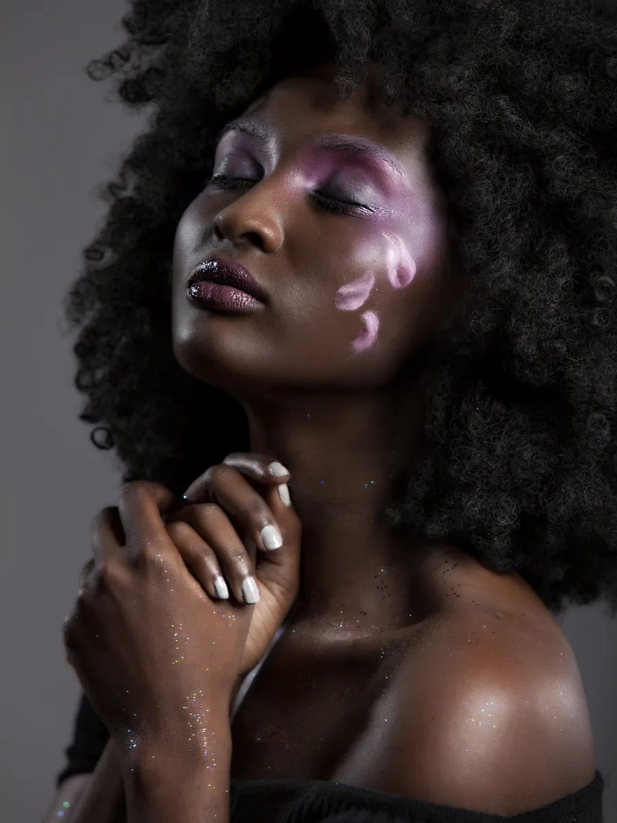 Editorial portrait with defined eyes and a rich lip colour